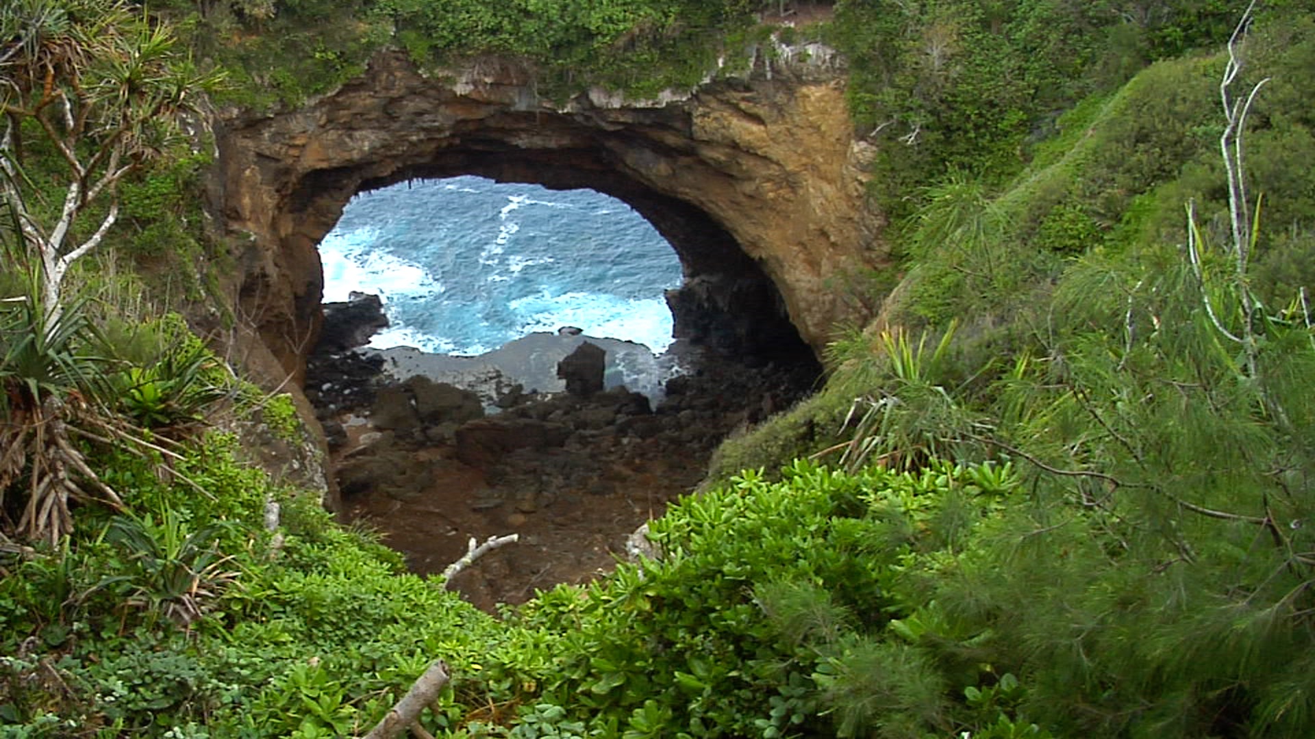 Ocean, tilts down to show rock arch, HD, UP16109