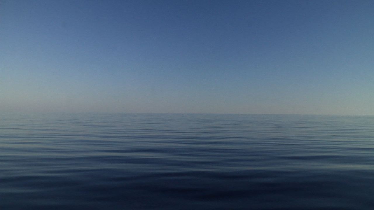 Ocean scenery slow travel over the ocean surface, oily calm, relaxing, title shot, in bluewater, HD, UP25556
